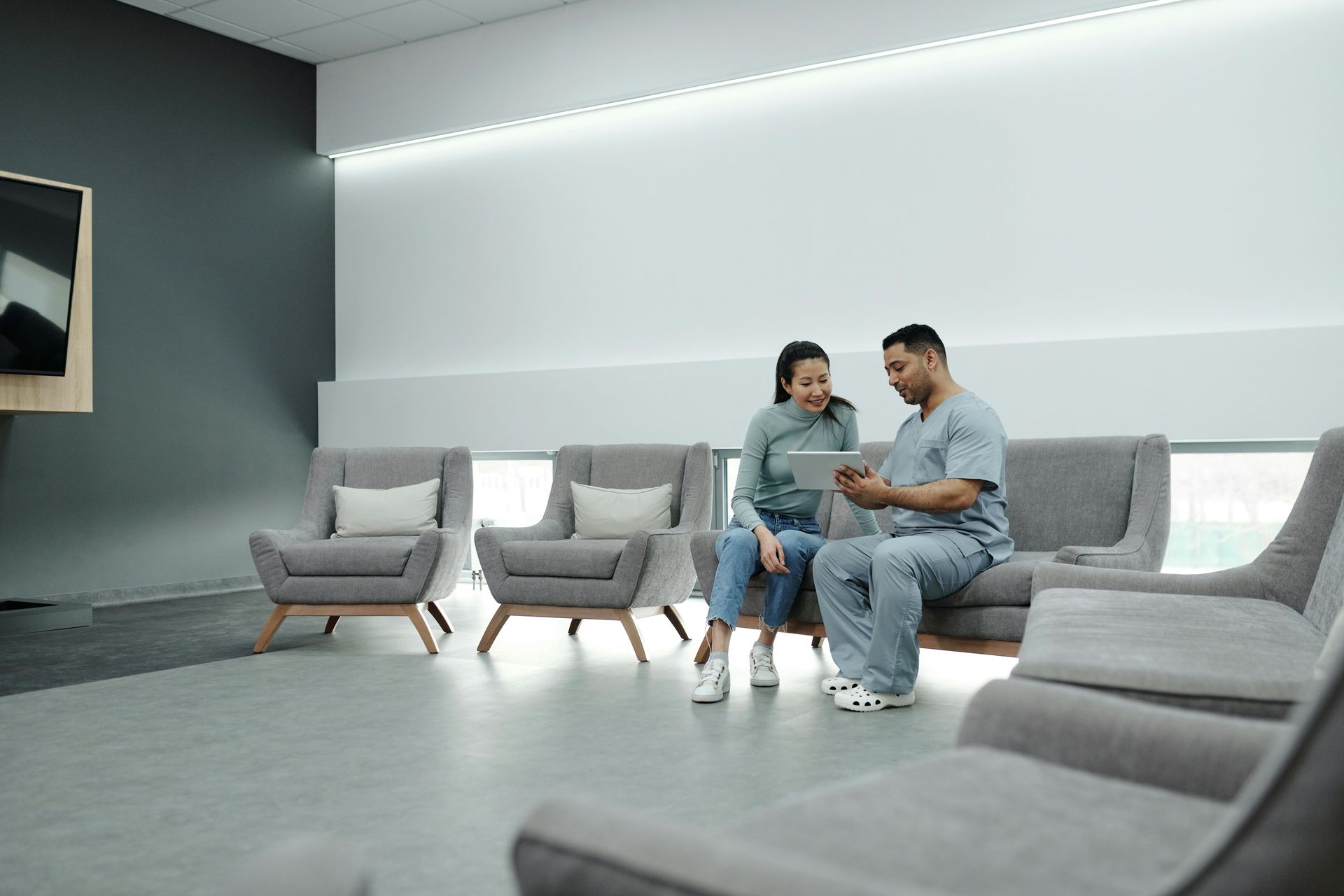 A male doctor talking to his female patient in the waiting area of a clinic specialized seo agency for healthcare